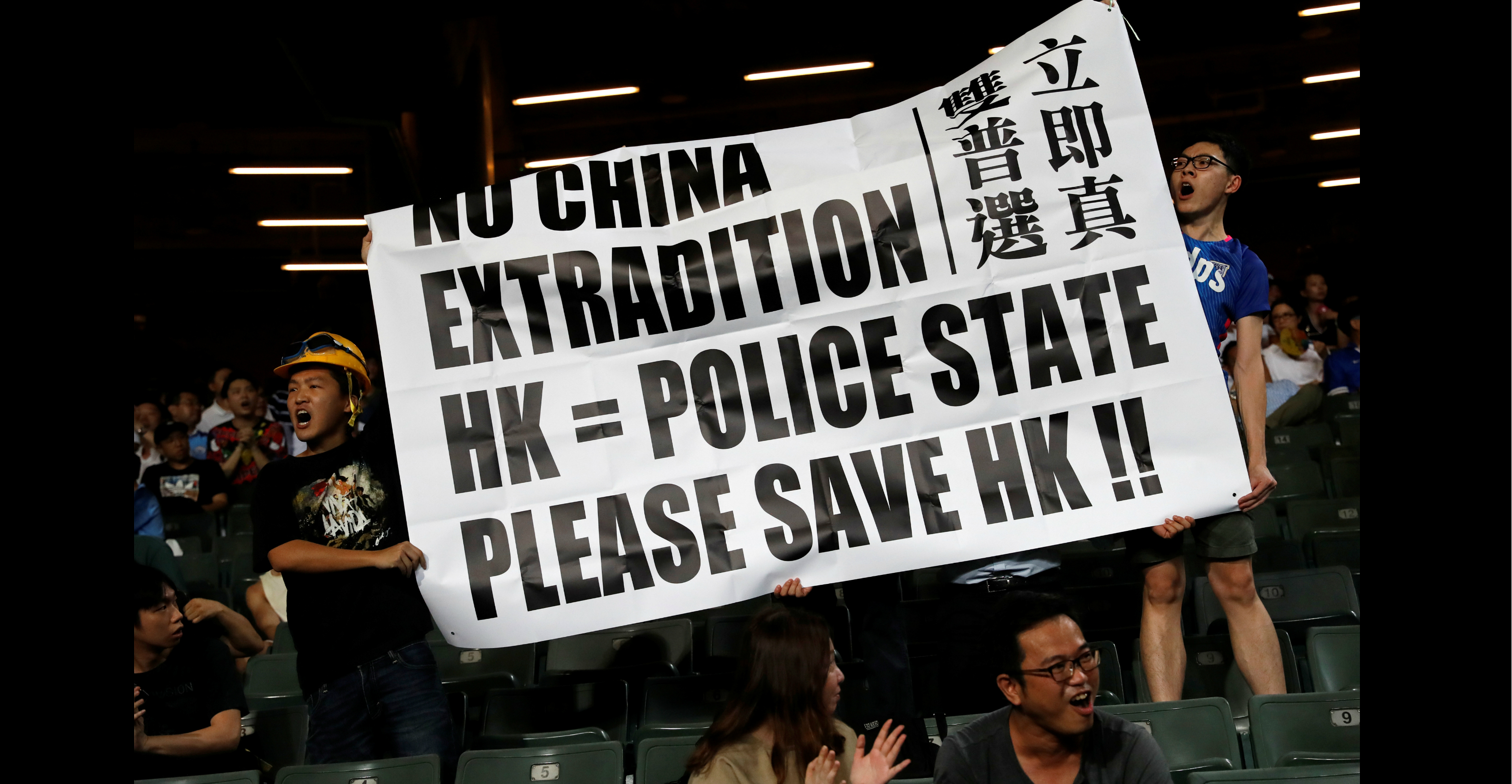 Fans hold an anti-extradition bill banner during a friendly match between Manchester City Football Club and Kitchee on Wednesday. Photo: Reuters Fans hold an anti-extradition bill banner during a friendly match between Manchester City Football Club and Kitchee on Wednesday. Photo: Reuters