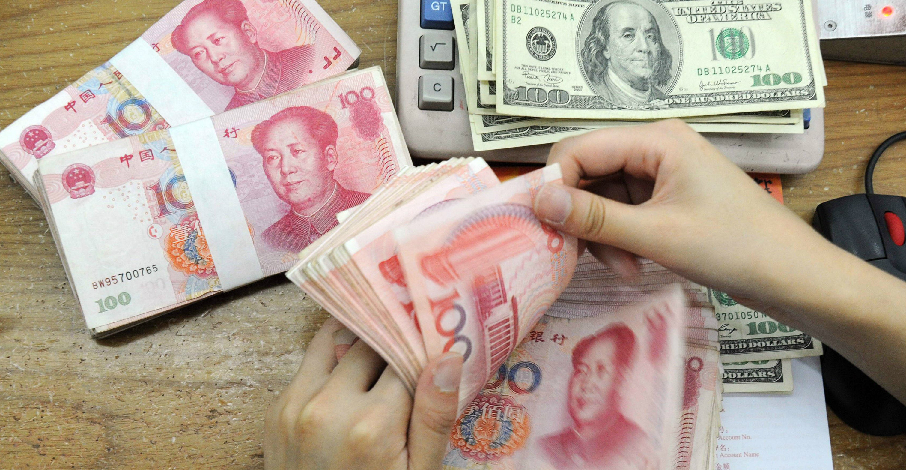 The yuan dropped to a record low in offshore trade early in Asia, after the US announcement, before bouncing to steady around 7.0642 per dollar. Photo: AFP The yuan dropped to a record low in offshore trade early in Asia, after the US announcement, before bouncing to steady around 7.0642 per dollar. Photo: AFP
