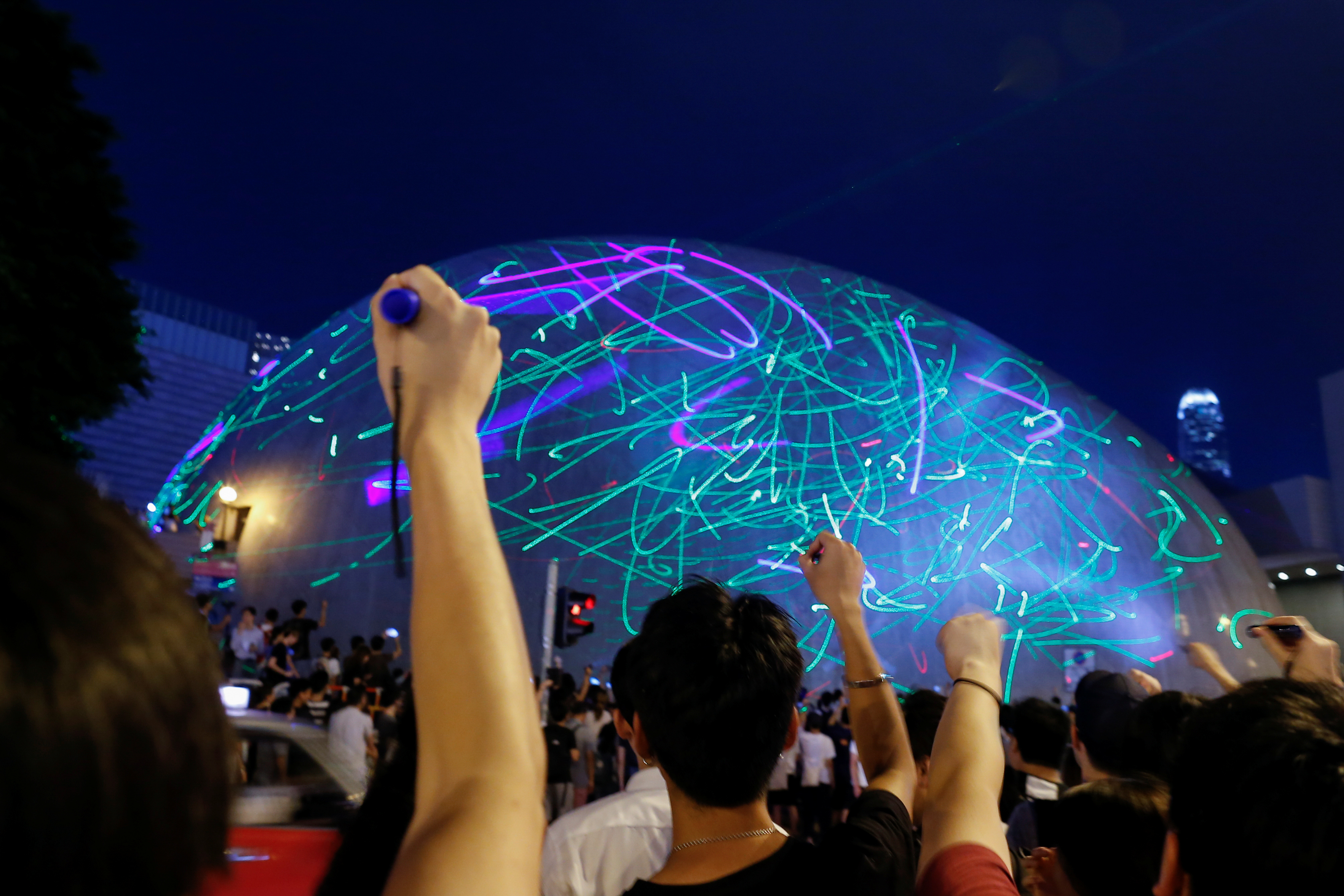 People watch the dots of laser pointers move across the facade of the Hong Kong Space Museum during a protest action on Aug. 7. The city’s youth have refused to be cowed down by warnings from the establishment. Photo: Reuters People watch the dots of laser pointers move across the facade of the Hong Kong Space Museum during a protest action on Aug. 7. The city’s youth have refused to be cowed down by warnings from the establishment. Photo: Reuters