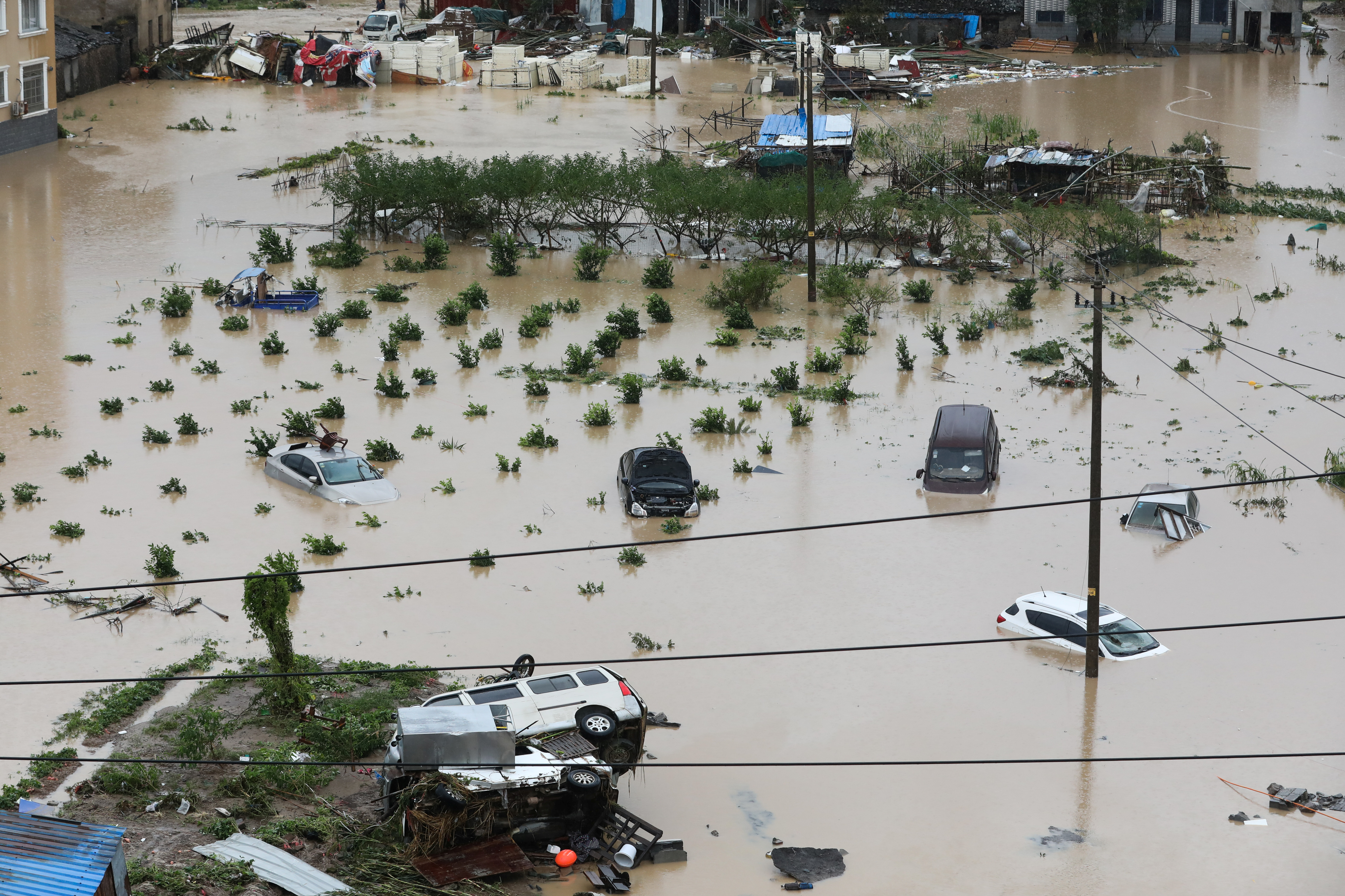 Cars are partially submerged in floodwaters after Typhoon Lekima hit Dajing town in Wenzhou, Zhejiang province, in China on August 10. Photo: Zhejiang Daily Press Group via Reuters Cars are partially submerged in floodwaters after Typhoon Lekima hit Dajing town in Wenzhou, Zhejiang province, in China on August 10. Photo: Zhejiang Daily Press Group via Reuters