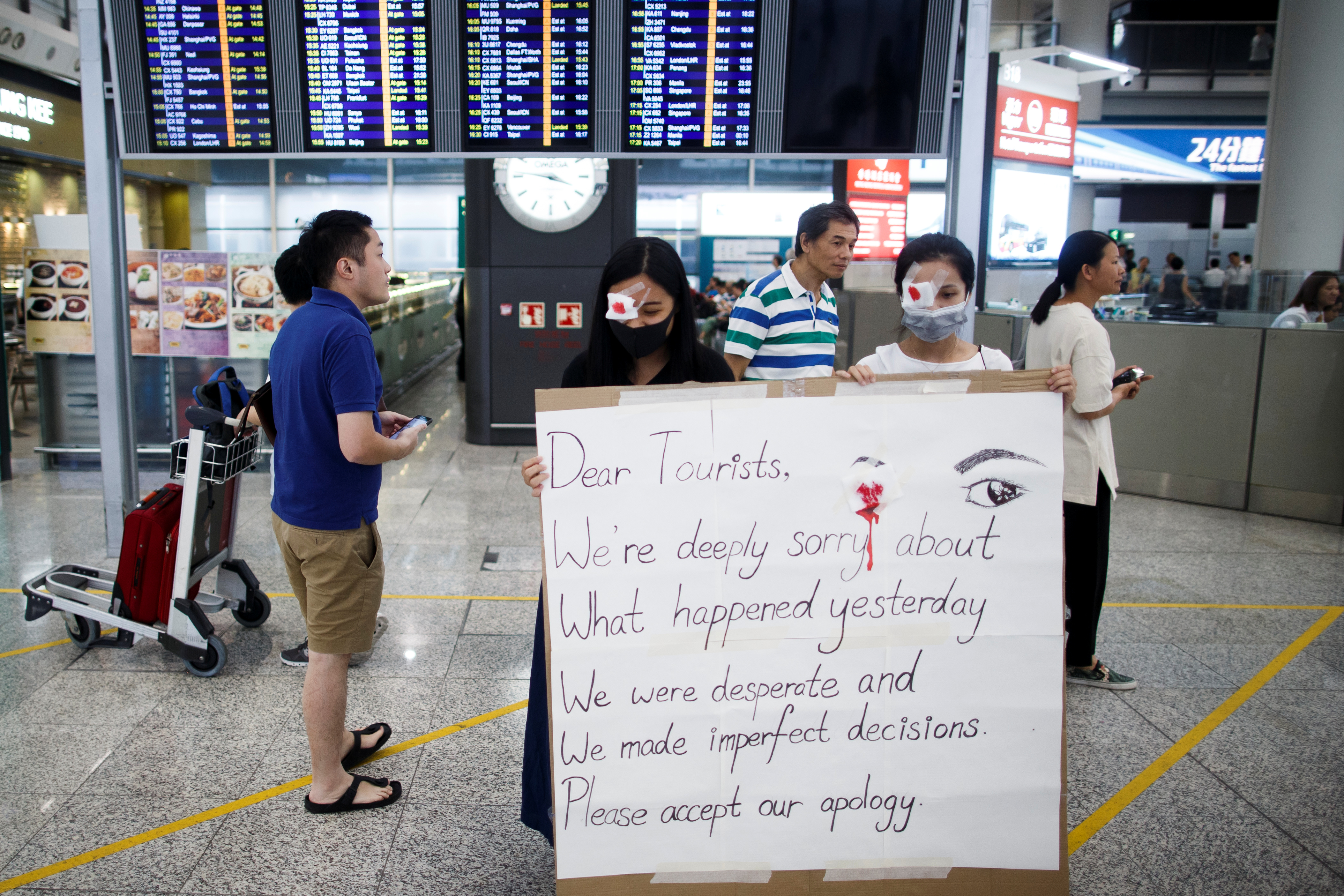 Demonstrators apologize on Wednesday for violent incidents and chaos at the Hong Kong airport the previous day. Photo: Reuters Demonstrators apologize on Wednesday for violent incidents and chaos at the Hong Kong airport the previous day. Photo: Reuters