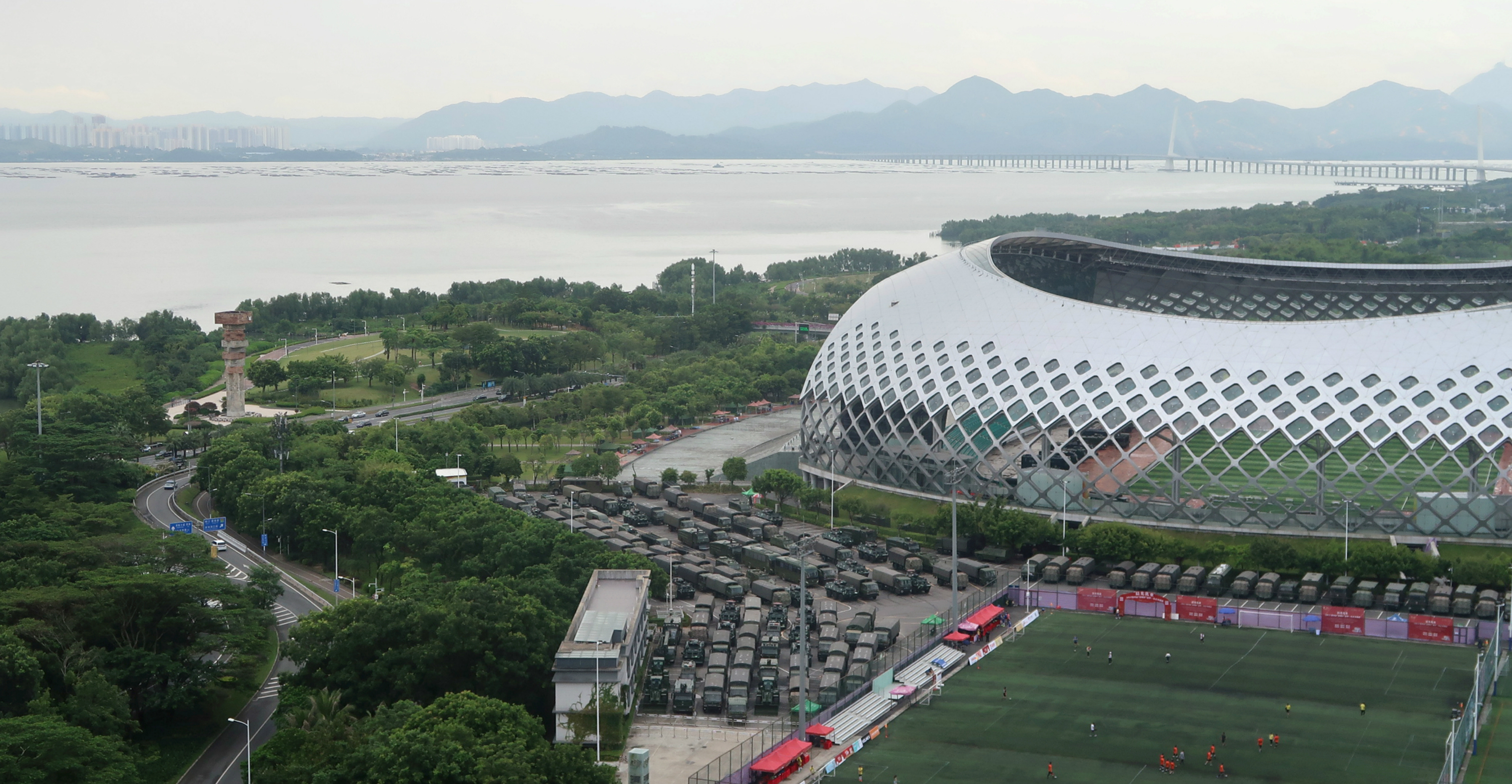 Chinese paramilitary vehicles are parked at the Shenzhen Bay Sports Center in Shenzhen near the border with Hong Kong on Saturday. Photo: Reuters Chinese paramilitary vehicles are parked at the Shenzhen Bay Sports Center in Shenzhen near the border with Hong Kong on Saturday. Photo: Reuters