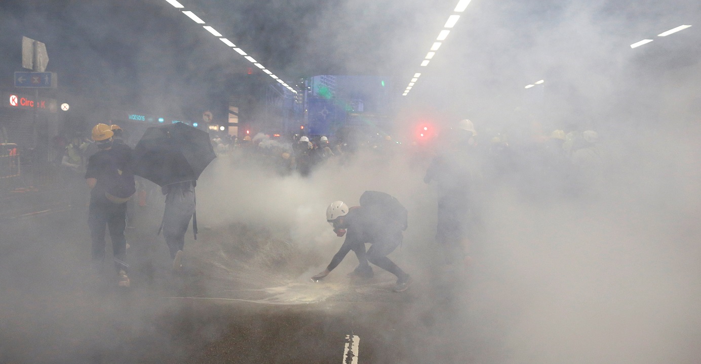 Demonstrators react as they face tear gas during an anti-government protest in Tai Wai on Aug. 10. Hong Kong police have been accused of excessive and reckless use of tear gas in dealing with the ongoing street protests in the city. Photo: Reuters Demonstrators react as they face tear gas during an anti-government protest in Tai Wai on Aug. 10. Hong Kong police have been accused of excessive and reckless use of tear gas in dealing with the ongoing street protests in the city. Photo: Reuters