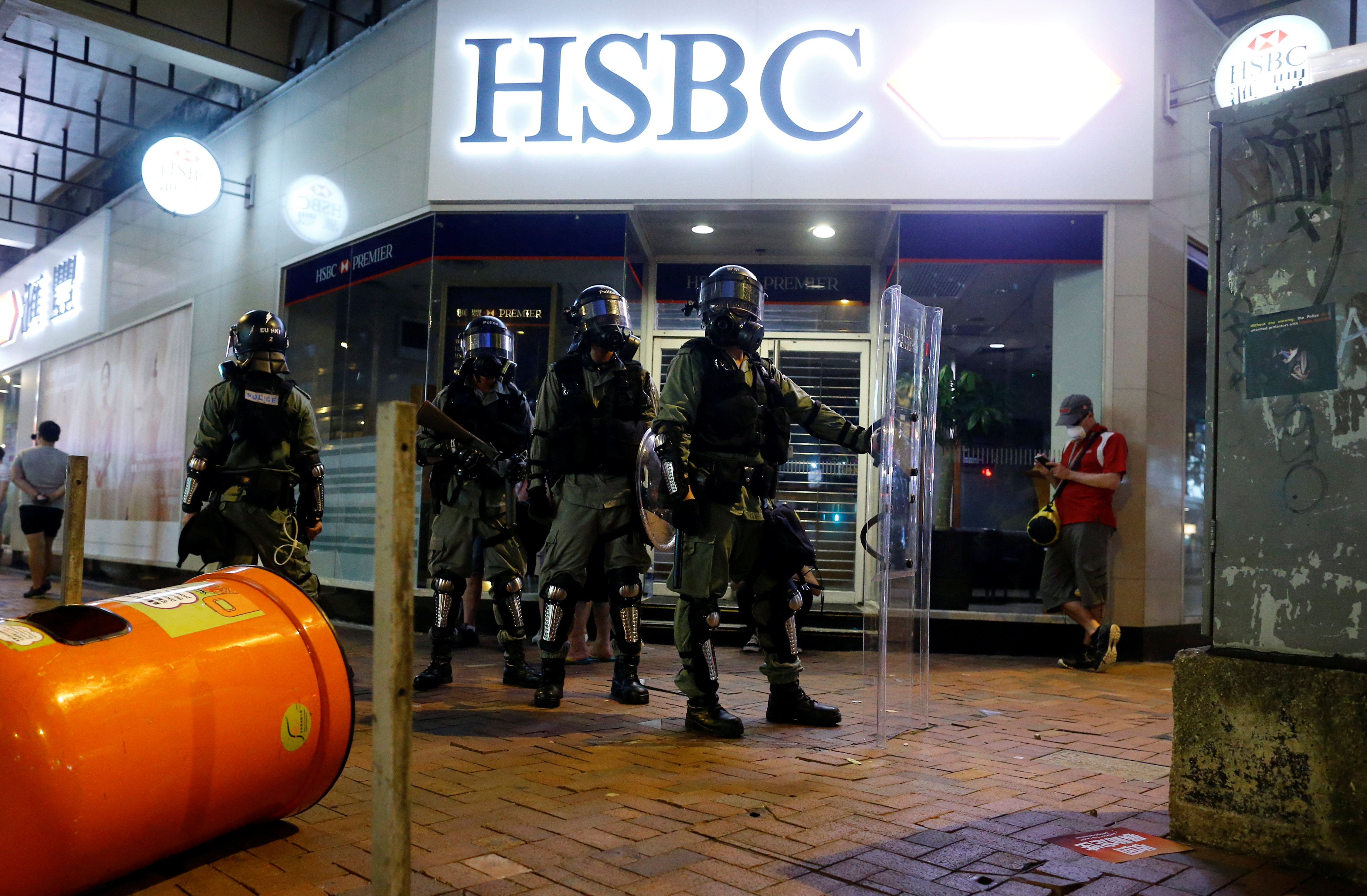 Riot police officers stand outside a HSBC branch in Hong Kong during an anti-extradition bill protest on Aug 11. The bank has announced some measures to help SMEs in the wake of the social unrest in the city. Photo: Reuters Riot police officers stand outside a HSBC branch in Hong Kong during an anti-extradition bill protest on Aug 11. The bank has announced some measures to help SMEs in the wake of the social unrest in the city. Photo: Reuters