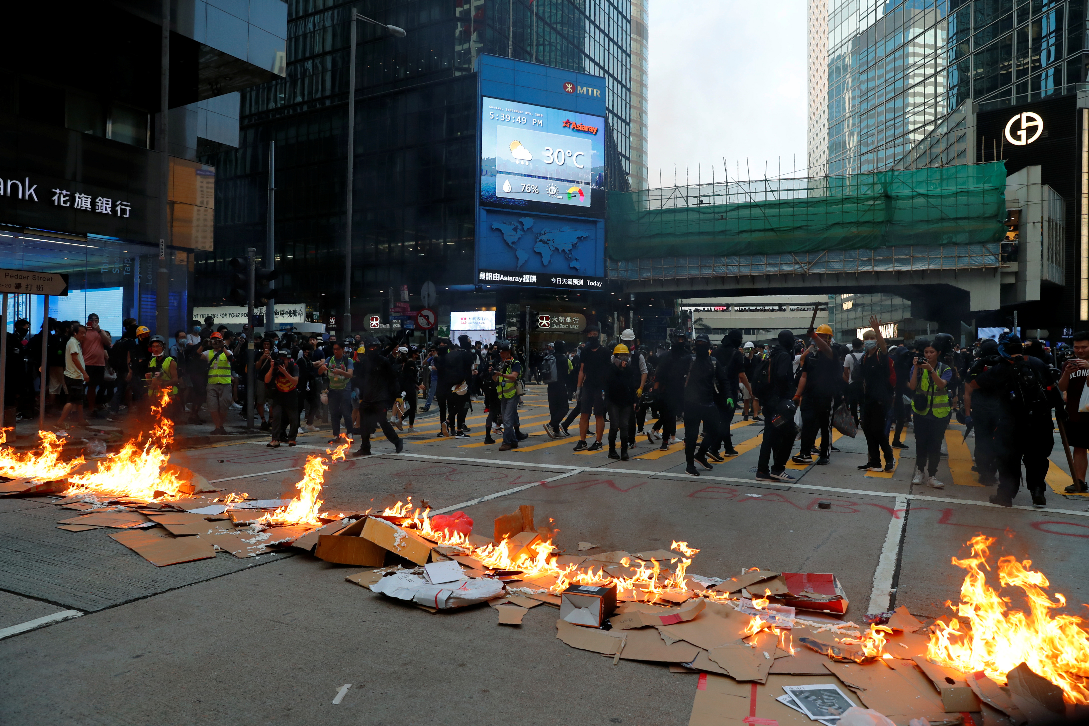 Protestors leave after lighting fire on a road during a rally in Hong Kong on Sunday. The unrest triggered by the extradition bill shows no signs of ending despite the withdrawal of the bill by the government. Photo: Reuters Protestors leave after lighting fire on a road during a rally in Hong Kong on Sunday. The unrest triggered by the extradition bill shows no signs of ending despite the withdrawal of the bill by the government. Photo: Reuters