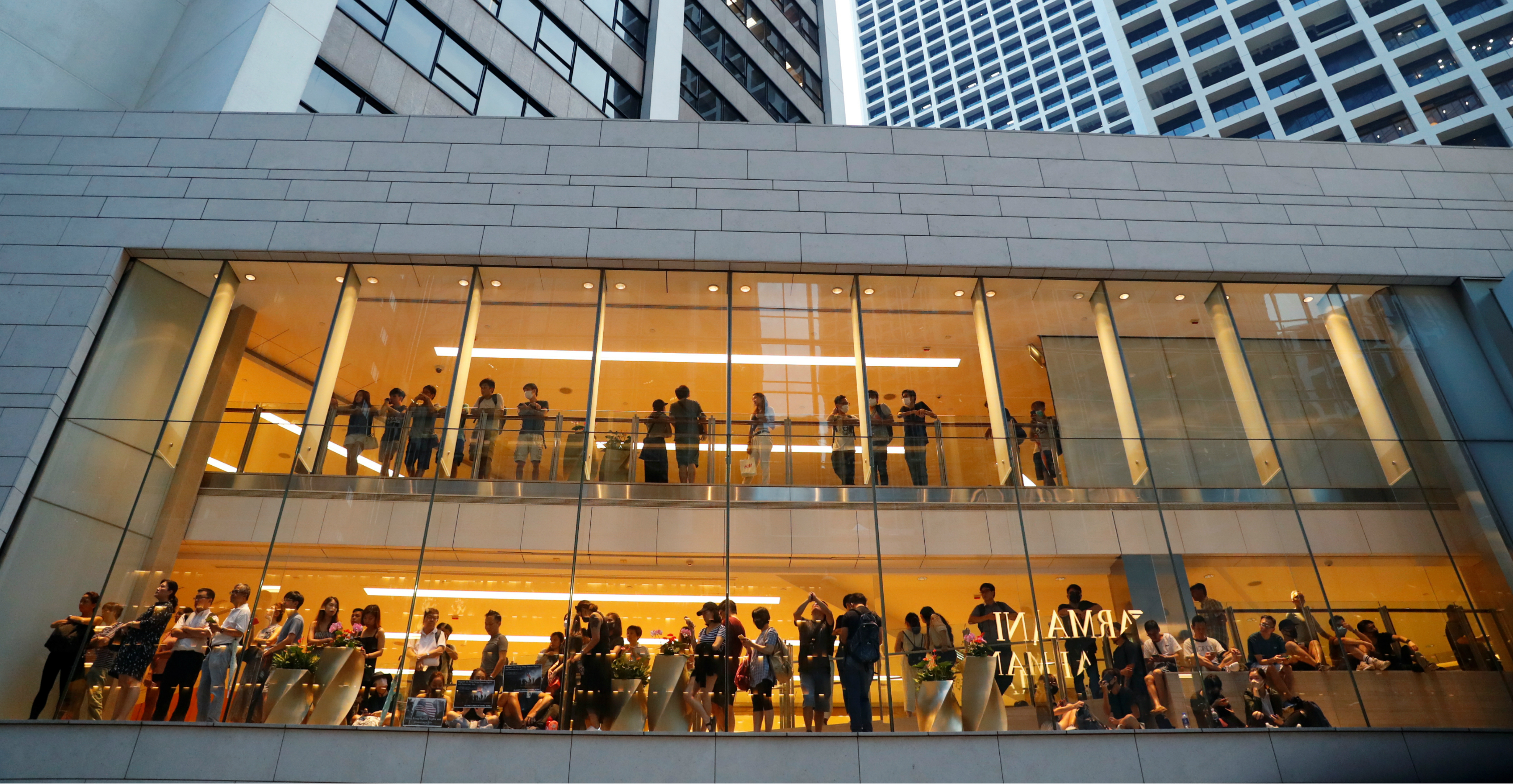 People watch a protest from a shop in Central on Sunday. Photo: Reuters People watch a protest from a shop in Central on Sunday. Photo: Reuters