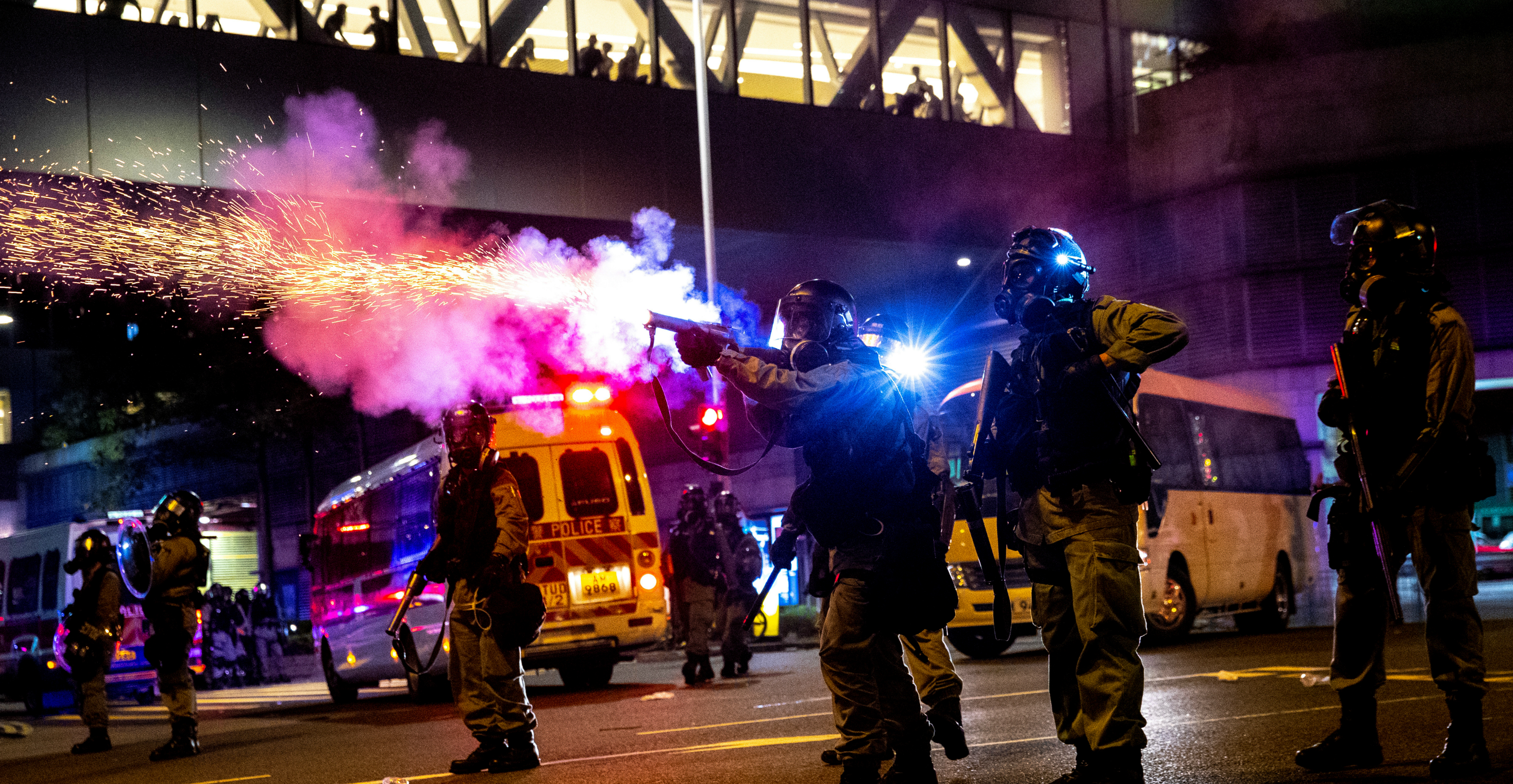 Riot police fire tear gas toward anti-government protesters during a demonstration in Tseung Kwan O on Monday. Photo: Reuters Riot police fire tear gas toward anti-government protesters during a demonstration in Tseung Kwan O on Monday. Photo: Reuters
