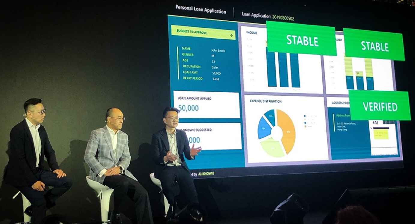 KBQuest chief executive Eric Moy (center) explains how Ai-Knowie is used in the auditing process for financial services. Photo: KBQuest KBQuest chief executive Eric Moy (center) explains how Ai-Knowie is used in the auditing process for financial services. Photo: KBQuest