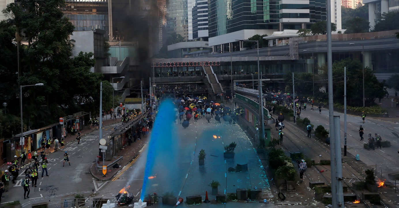 Riot police spray blue-colored water in a protest on Hong Kong Island on Oct. 1. When an authoritarian regime refuses to face people’s basic demands, people tend to have more and more demands, lawmaker Charles Mok points out. Photo: Reuters Riot police spray blue-colored water in a protest on Hong Kong Island on Oct. 1. When an authoritarian regime refuses to face people’s basic demands, people tend to have more and more demands, lawmaker Charles Mok points out. Photo: Reuters