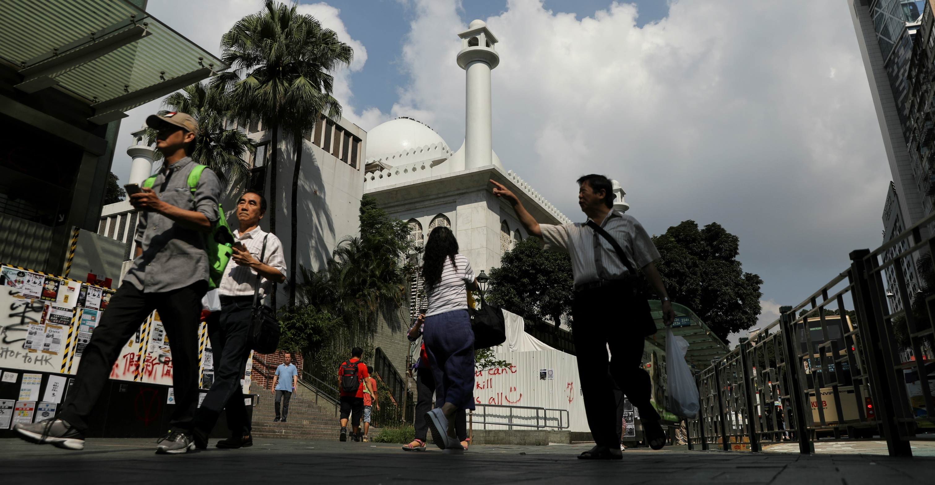 People walk past Kowloon Masjid and Islamic Centre in Tsim Sha Tsui on Monday. Photo: Reuters People walk past Kowloon Masjid and Islamic Centre in Tsim Sha Tsui on Monday. Photo: Reuters