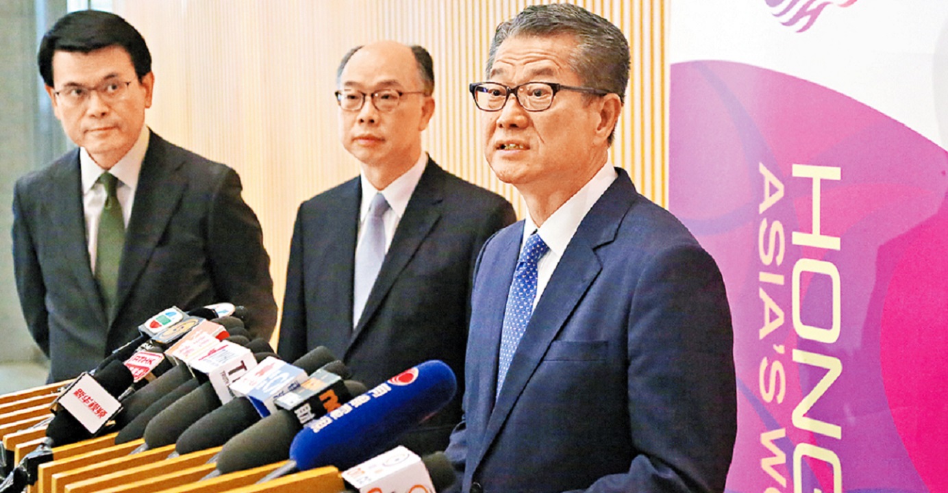 Financial Secretary Paul Chan (R) announces a new round of relief measures on Tuesday for businesses that have borne the brunt of Hong Kong's ongoing social unrest. Photo: HKEJ Financial Secretary Paul Chan (R) announces a new round of relief measures on Tuesday for businesses that have borne the brunt of Hong Kong's ongoing social unrest. Photo: HKEJ