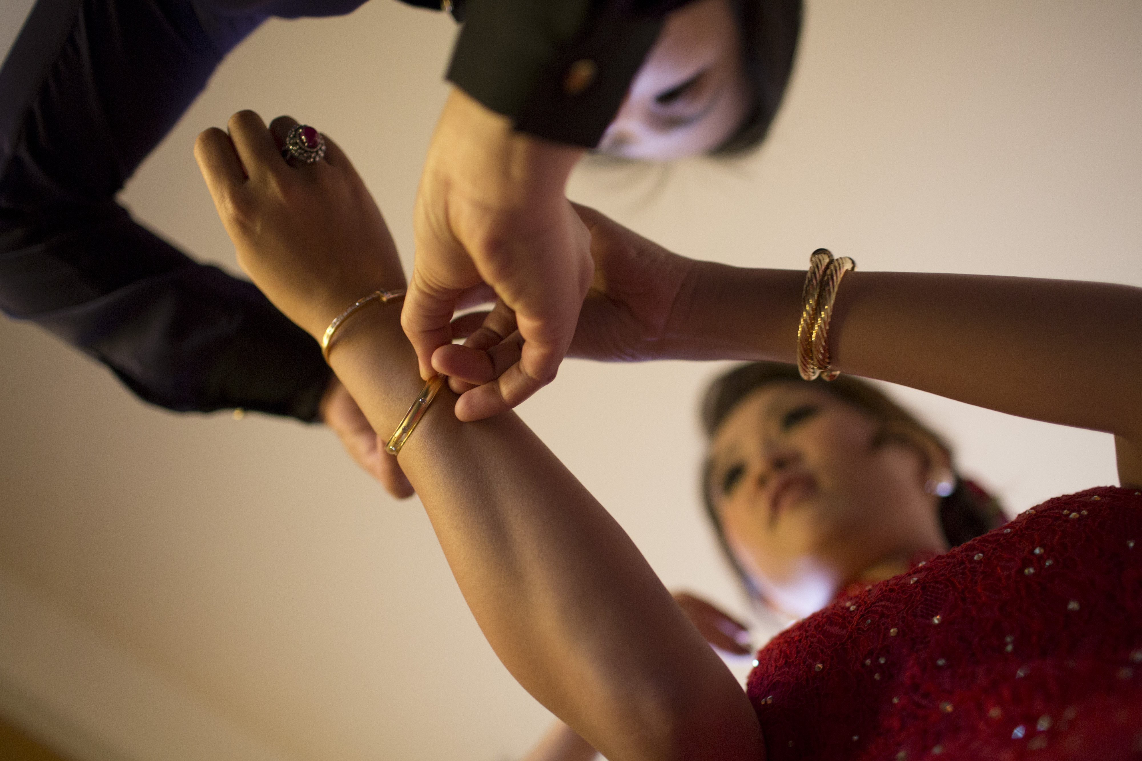 A file picture shows gold bangles being put on a bride's wrist during a wedding-related ceremony. Hong Kong’s social unrest is prompting some young people to rework their plans for weddings and related arrangements. Photo: Bloomberg A file picture shows gold bangles being put on a bride's wrist during a wedding-related ceremony. Hong Kong’s social unrest is prompting some young people to rework their plans for weddings and related arrangements. Photo: Bloomberg