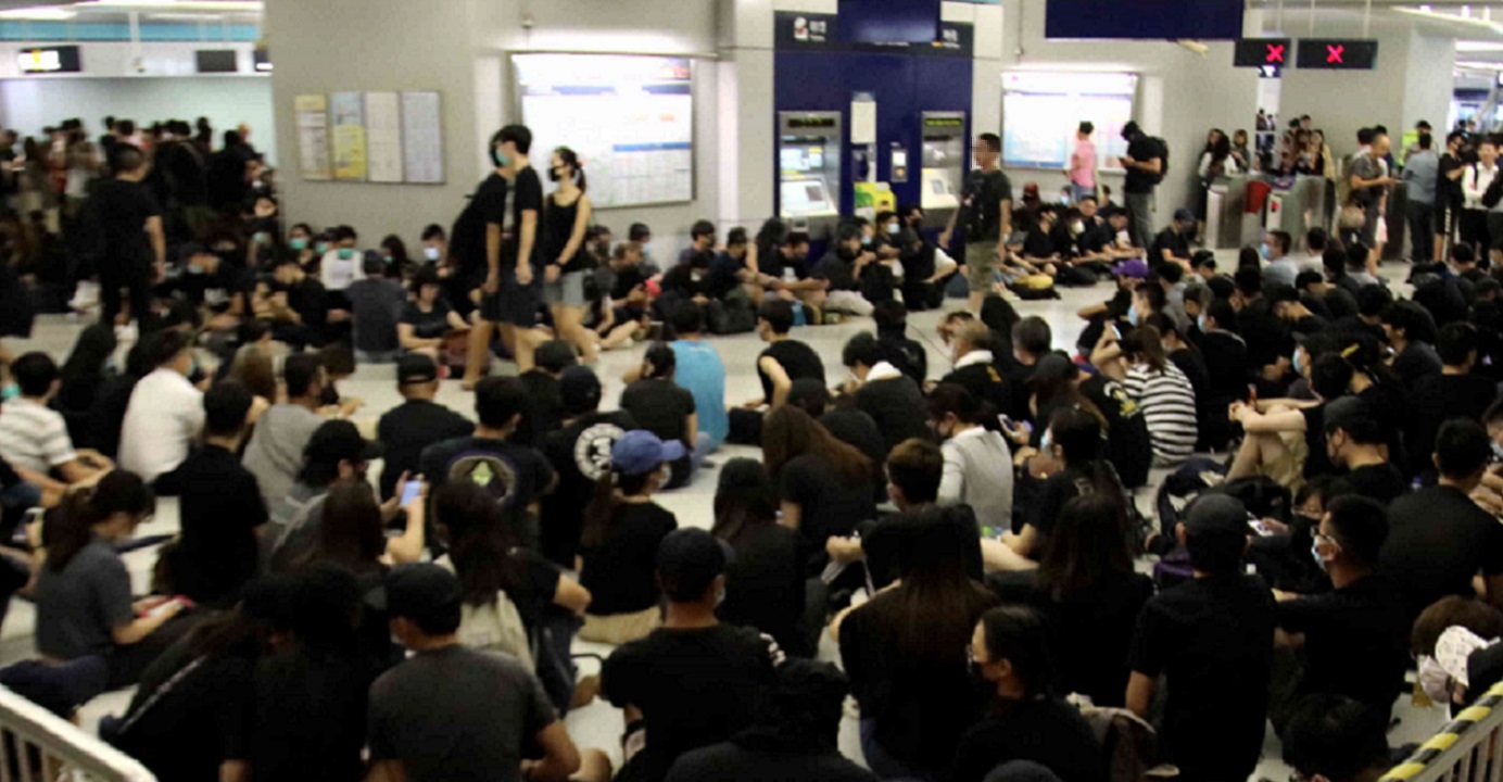 Protesters stage a sit-in at the Yuen Long MTR Station to mark the July 21 attacks. Photo: HKEJ Protesters stage a sit-in at the Yuen Long MTR Station to mark the July 21 attacks. Photo: HKEJ