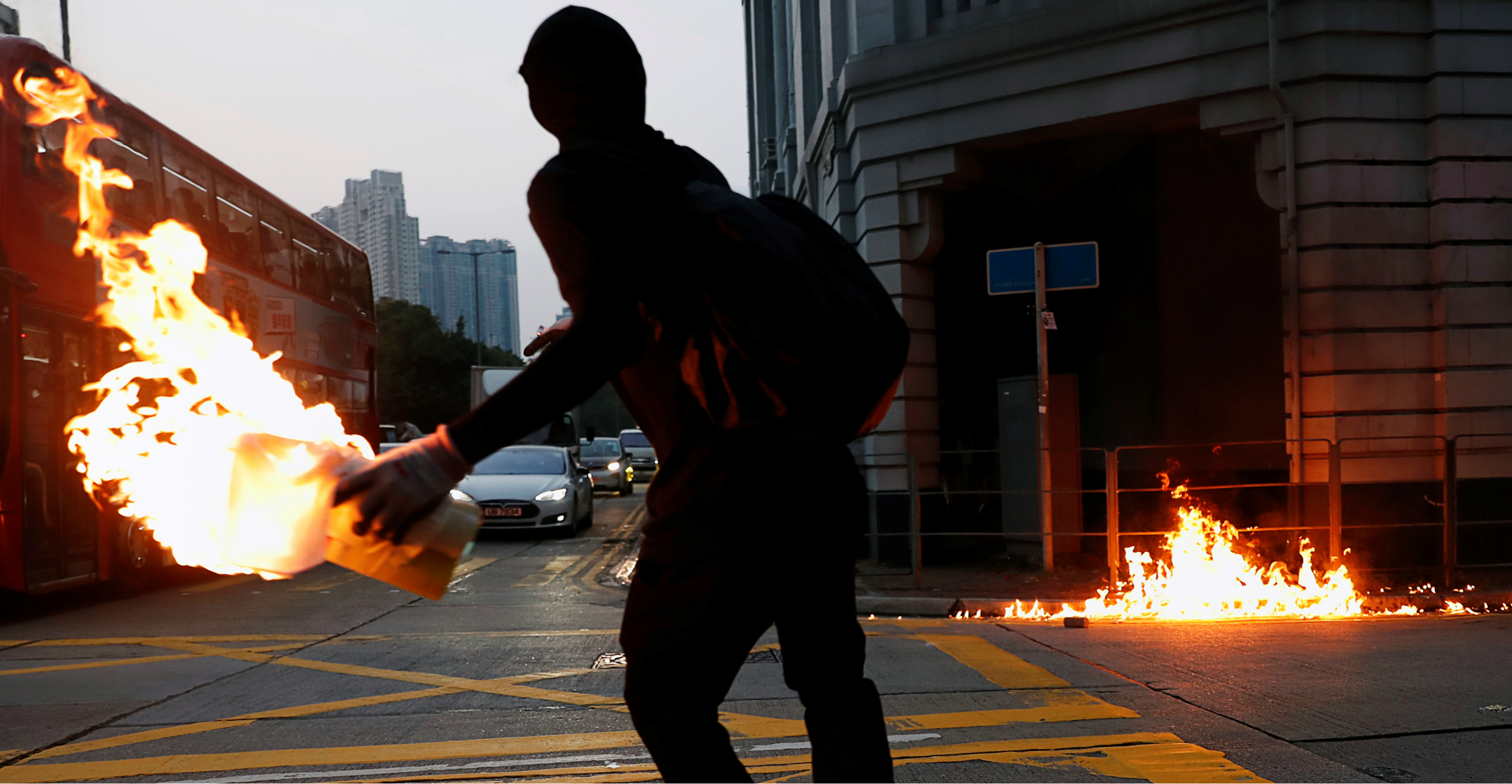 A black-clad protester hurls a petrol bomb at a police station in Sham Shui Po on Oct. 20. Photo: Reuters A black-clad protester hurls a petrol bomb at a police station in Sham Shui Po on Oct. 20. Photo: Reuters