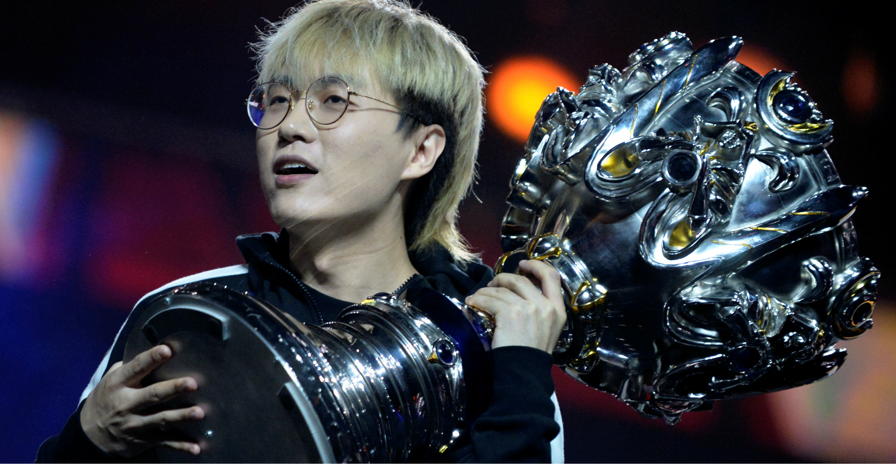 Chang "Xinyi" Ping of China's FunPlus Phoenix holds the trophy after winning the League of Legends World Championship Finals in Paris on Sunday. Photo: Reuters Chang "Xinyi" Ping of China's FunPlus Phoenix holds the trophy after winning the League of Legends World Championship Finals in Paris on Sunday. Photo: Reuters