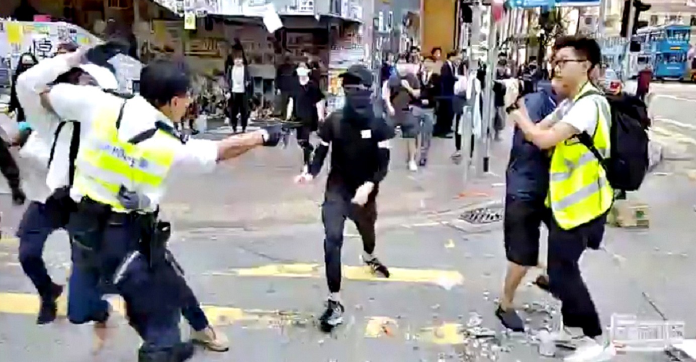 A still image from a social media video shows a police officer aiming his gun at a protester in Sai Wan Ho on Monday morning. Photo: Cupid Producer via Reuters A still image from a social media video shows a police officer aiming his gun at a protester in Sai Wan Ho on Monday morning. Photo: Cupid Producer via Reuters
