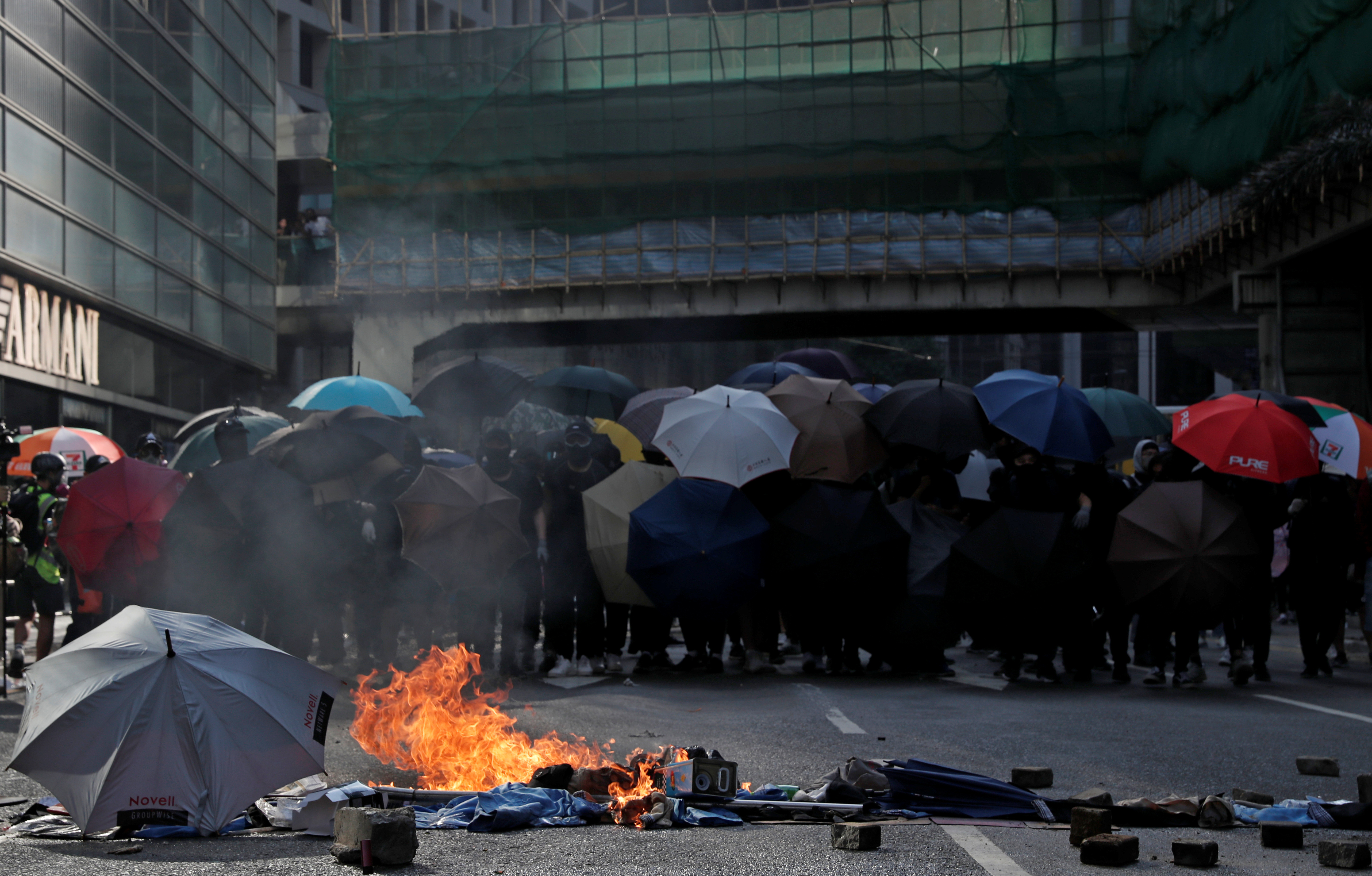 Demonstrators hold umbrellas during a lunchtime protest in Hong Kong’s Central district on Tuesday. Photo: Reuters Demonstrators hold umbrellas during a lunchtime protest in Hong Kong’s Central district on Tuesday. Photo: Reuters