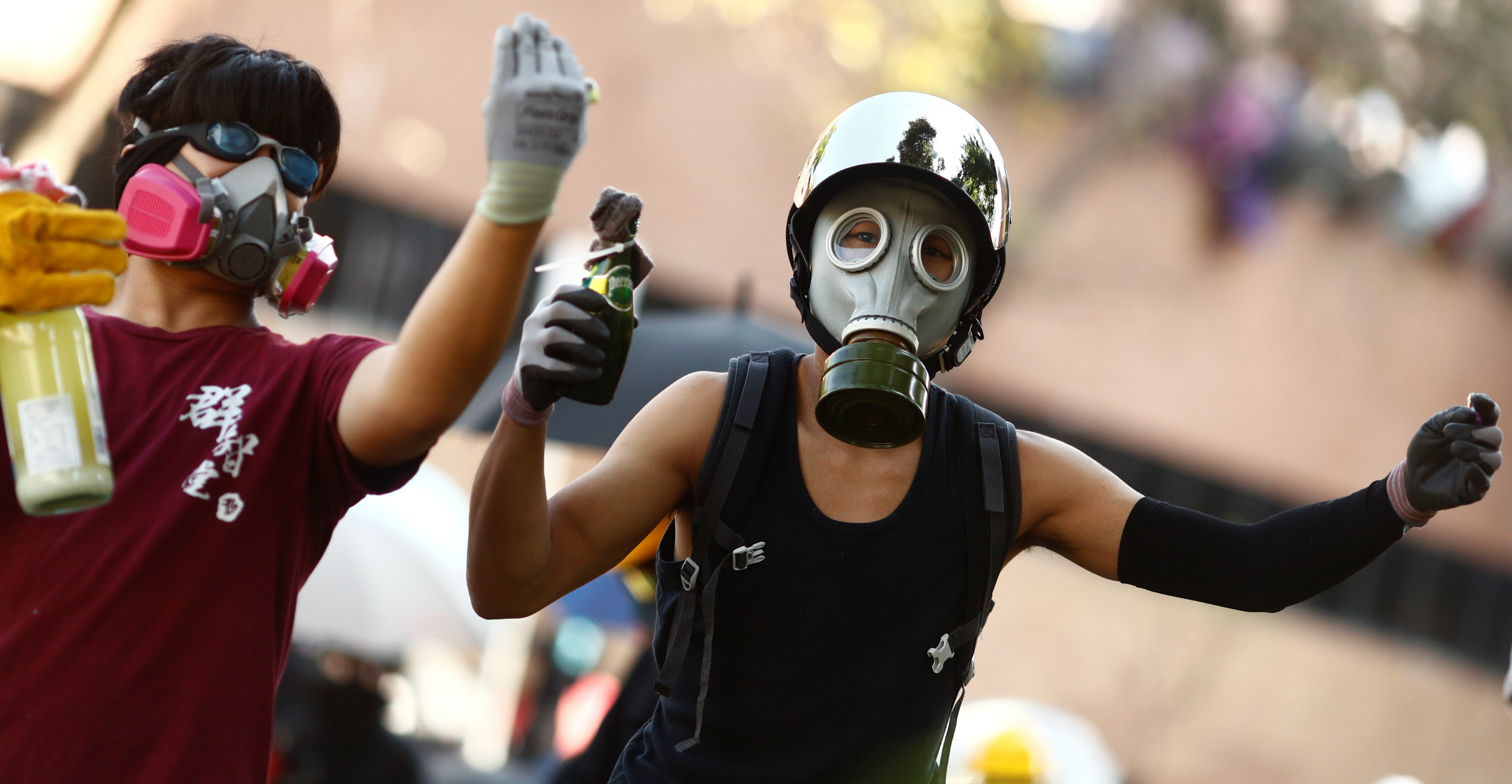 Protesters wear gas masks during clashes with police outside Hong Kong Polytechnic University in Hung Hom on Sunday. Photo: Reuters Protesters wear gas masks during clashes with police outside Hong Kong Polytechnic University in Hung Hom on Sunday. Photo: Reuters