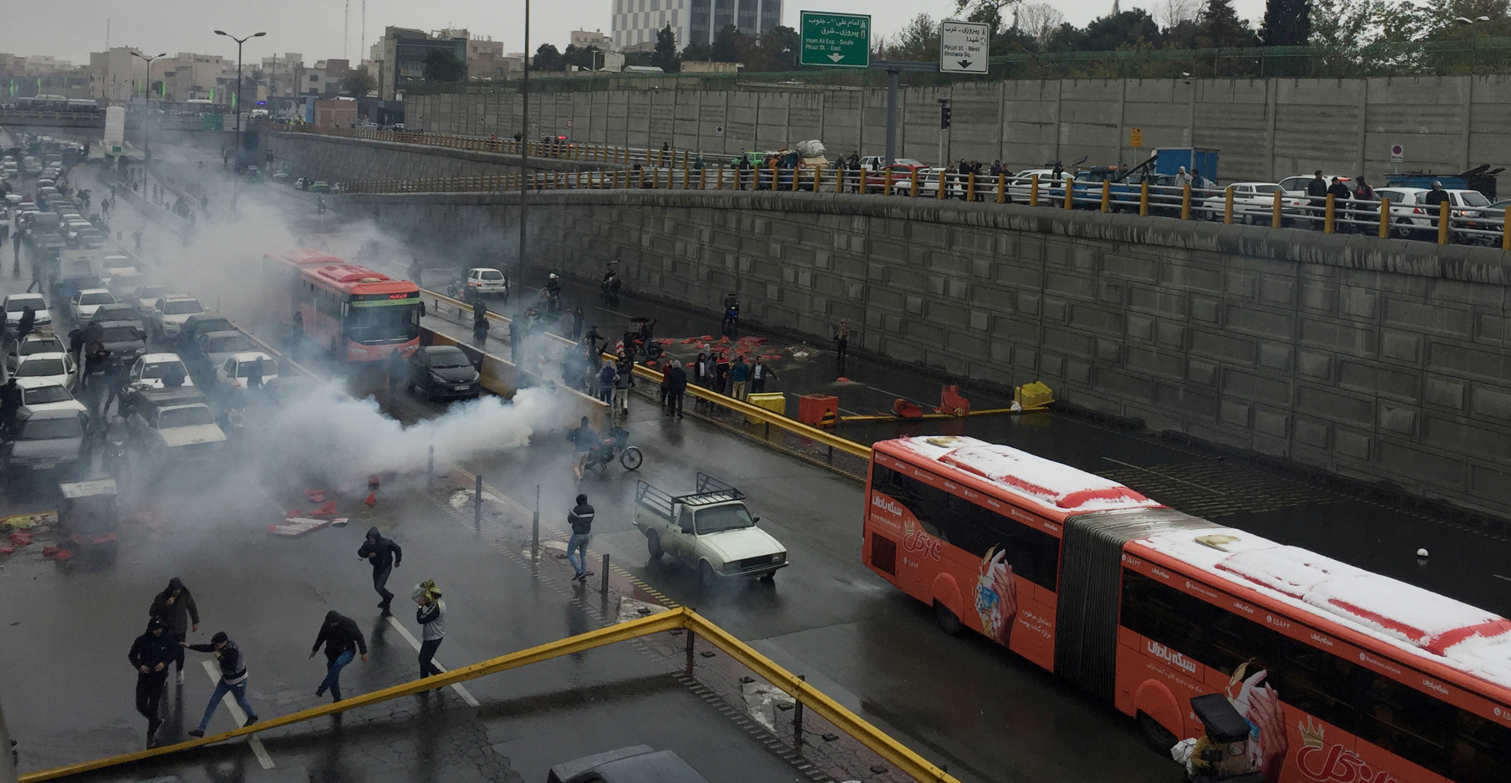 Riot police disperse people on a highway during a protest against a fuel price hike in Tehran on Saturday. Photo: West Asia News Agency via Reuters Riot police disperse people on a highway during a protest against a fuel price hike in Tehran on Saturday. Photo: West Asia News Agency via Reuters