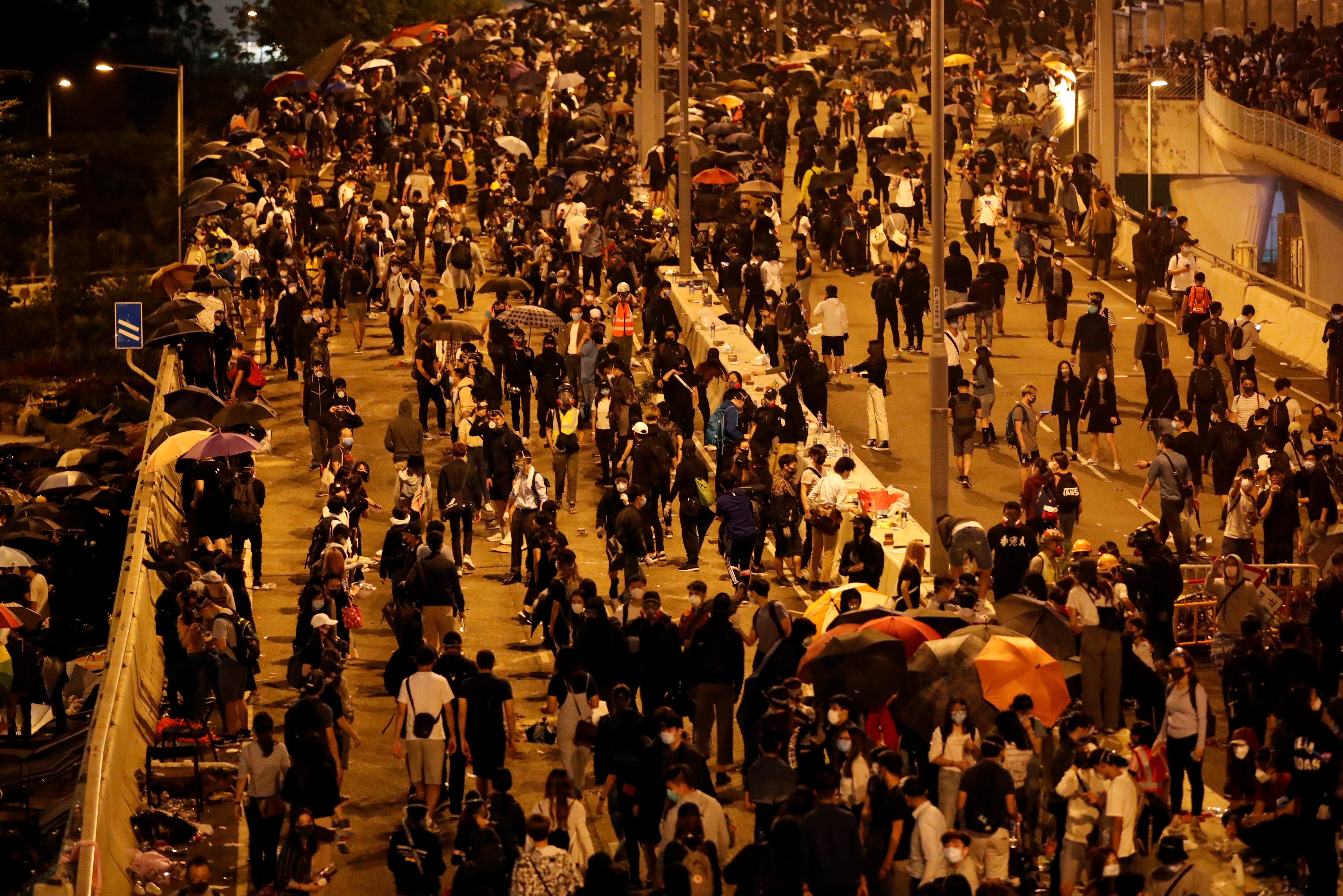 Anti-government demonstrators block a road near Polytechnic University on Nov. 18. Hong Kong’s upcoming district council elections have assumed added significance in the view of the months-long social unrest in the city. Photo: Reuters Anti-government demonstrators block a road near Polytechnic University on Nov. 18. Hong Kong’s upcoming district council elections have assumed added significance in the view of the months-long social unrest in the city. Photo: Reuters