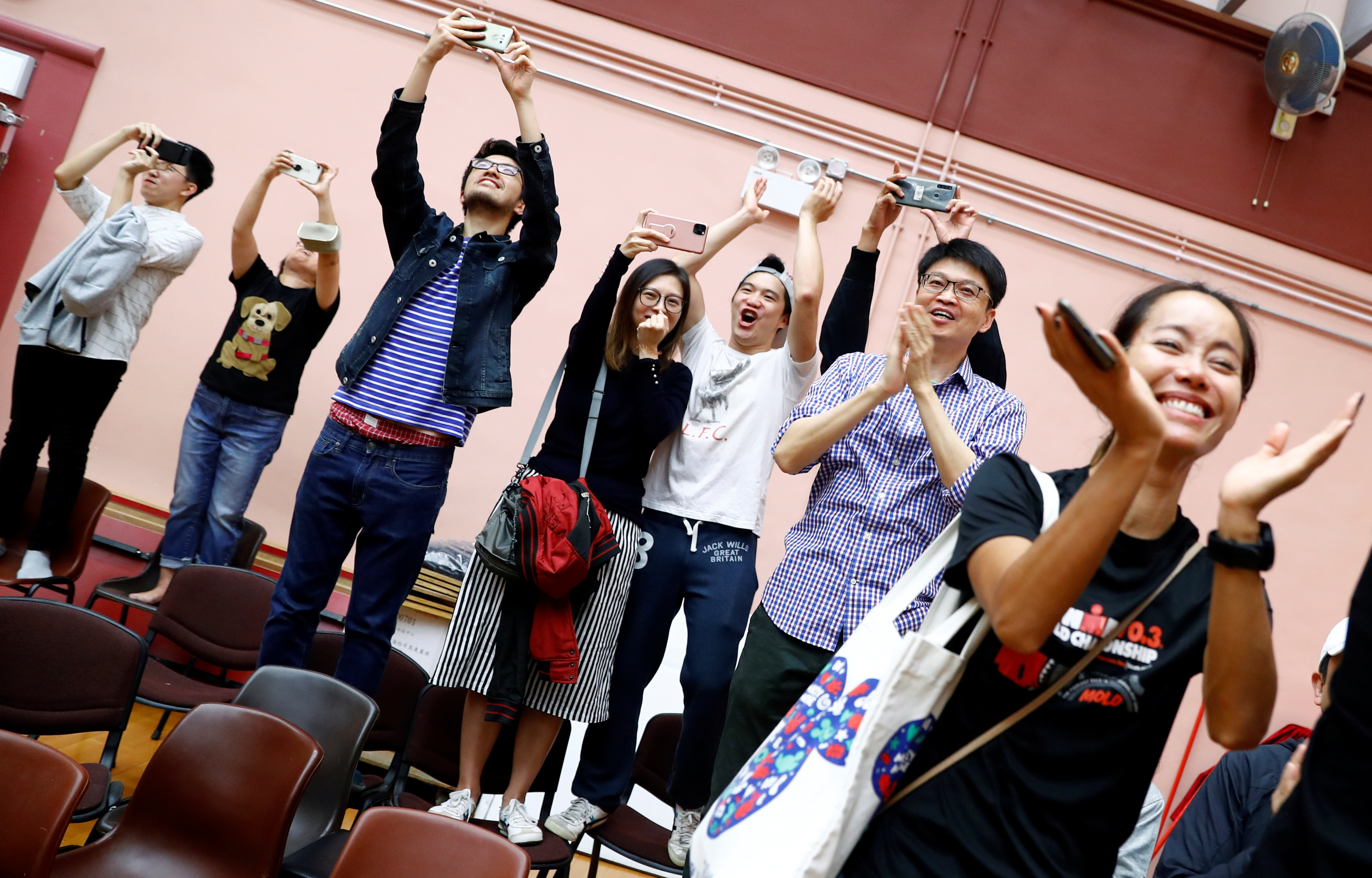 Kelvin Lam’s supporters celebrate early Monday after learning of their candidate's triumph in the district council election contest. Lam had stood in after activist Joshua Wong was barred from running in the DC polls. Photo: Reuters Kelvin Lam’s supporters celebrate early Monday after learning of their candidate's triumph in the district council election contest. Lam had stood in after activist Joshua Wong was barred from running in the DC polls. Photo: Reuters