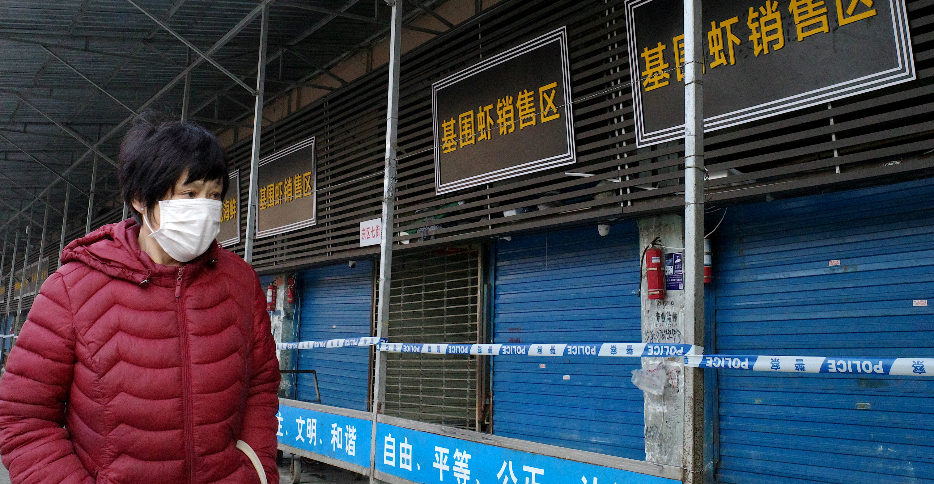 A woman walks in front of the closed Huanan Seafood Wholesale Market in Wuhan on Sunday. Photo: AFP A woman walks in front of the closed Huanan Seafood Wholesale Market in Wuhan on Sunday. Photo: AFP