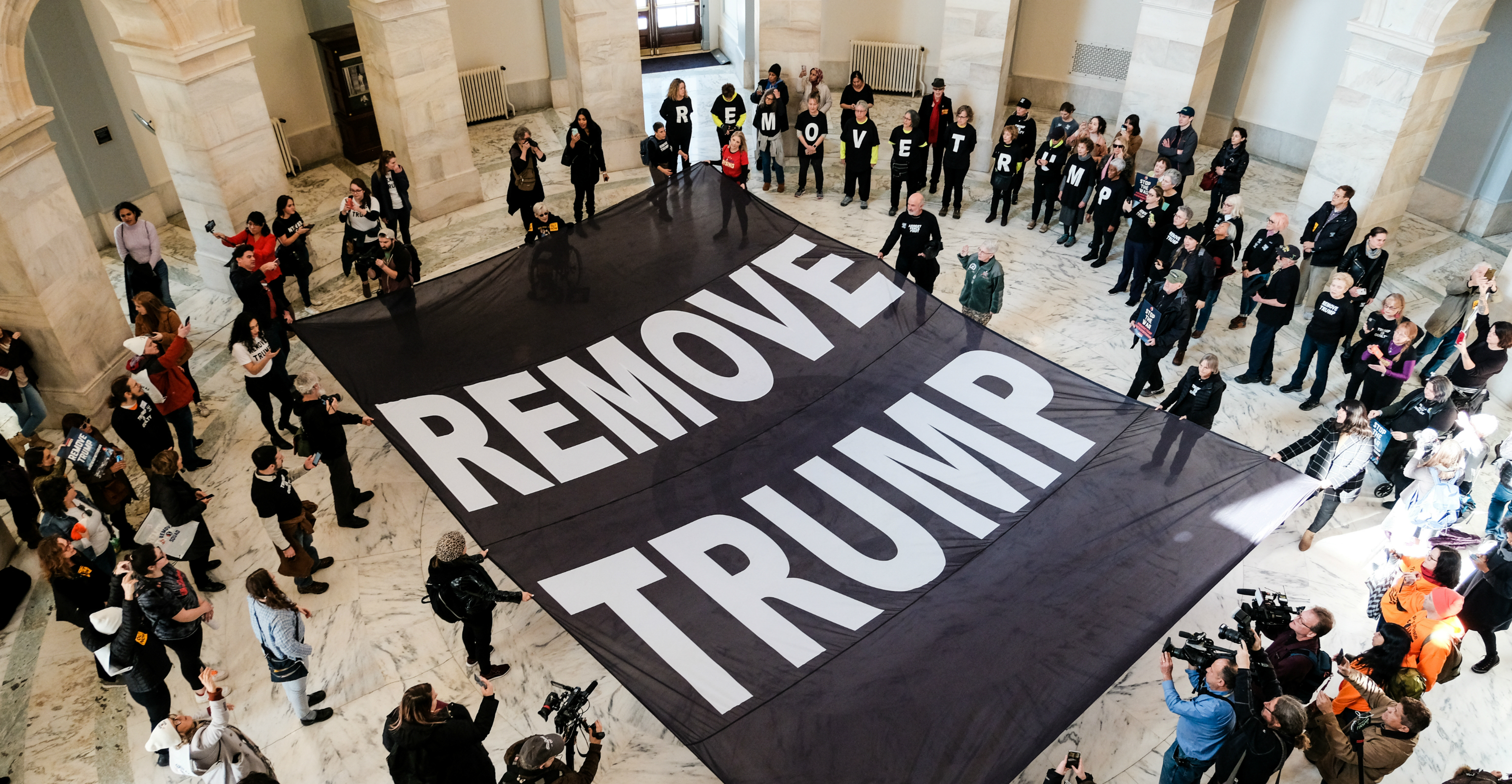 Activists spread out a banner calling for the removal of US President Donald Trump on the floor of the Russell Senate Office Building during a demonstration on Capitol Hill in Washington on Thursday. Photo: Reuters Activists spread out a banner calling for the removal of US President Donald Trump on the floor of the Russell Senate Office Building during a demonstration on Capitol Hill in Washington on Thursday. Photo: Reuters