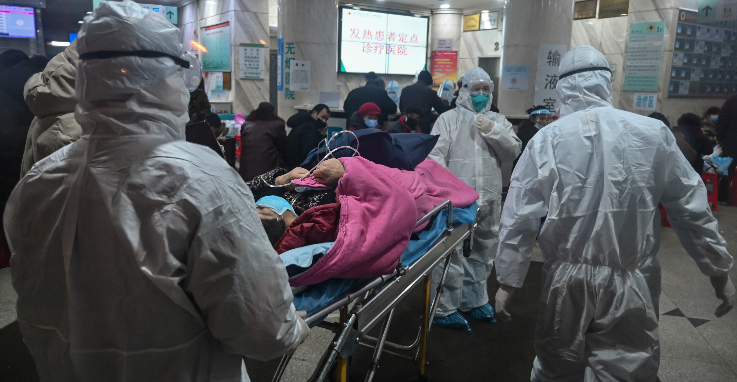 Medical staff wearing protective clothing arrive with a patient at the Wuhan Red Cross Hospital in Wuhan on Saturday. Photo: Reuters Medical staff wearing protective clothing arrive with a patient at the Wuhan Red Cross Hospital in Wuhan on Saturday. Photo: Reuters