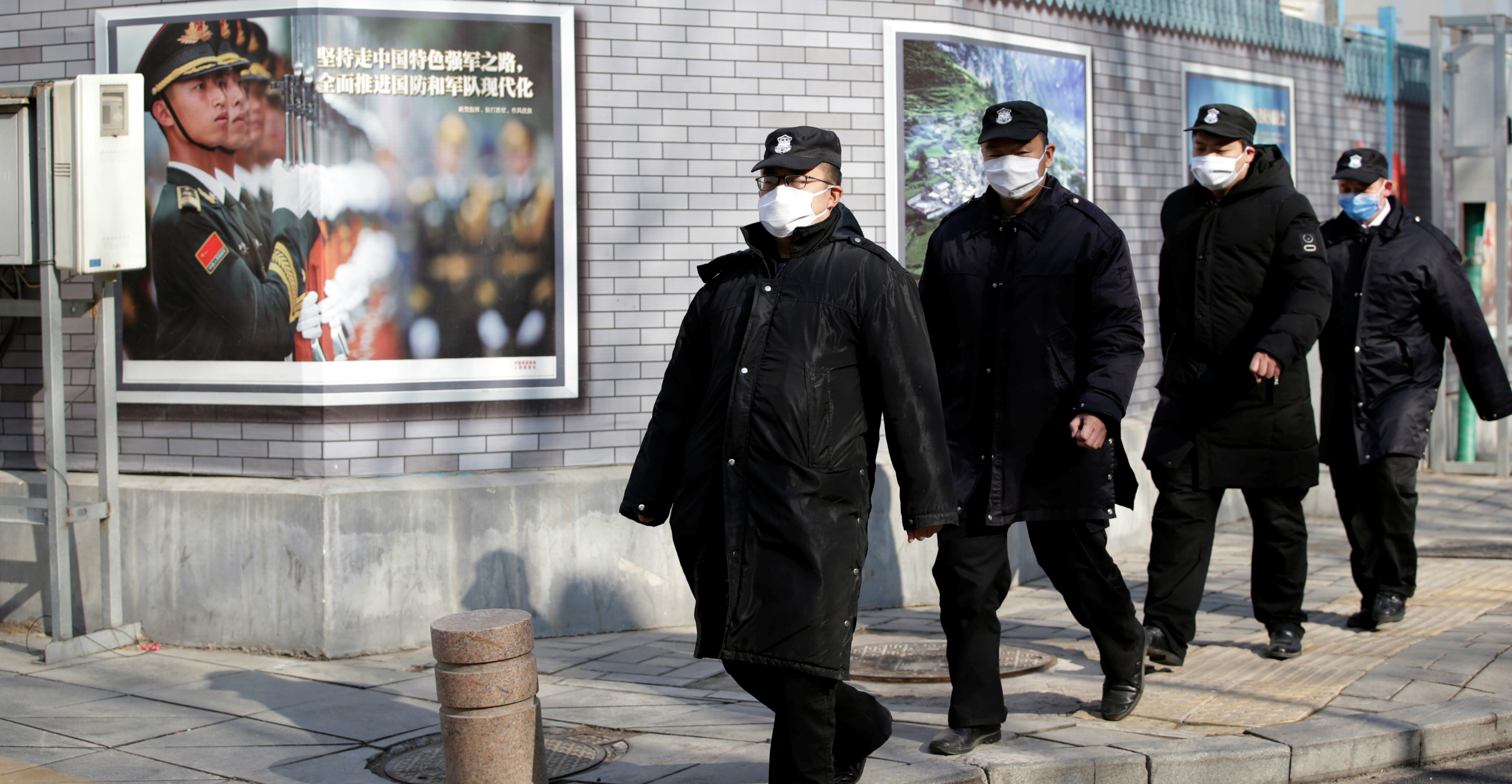 Security personnel wearing masks walk along Financial Street in central Beijing on Monday. Photo: Reuters Security personnel wearing masks walk along Financial Street in central Beijing on Monday. Photo: Reuters