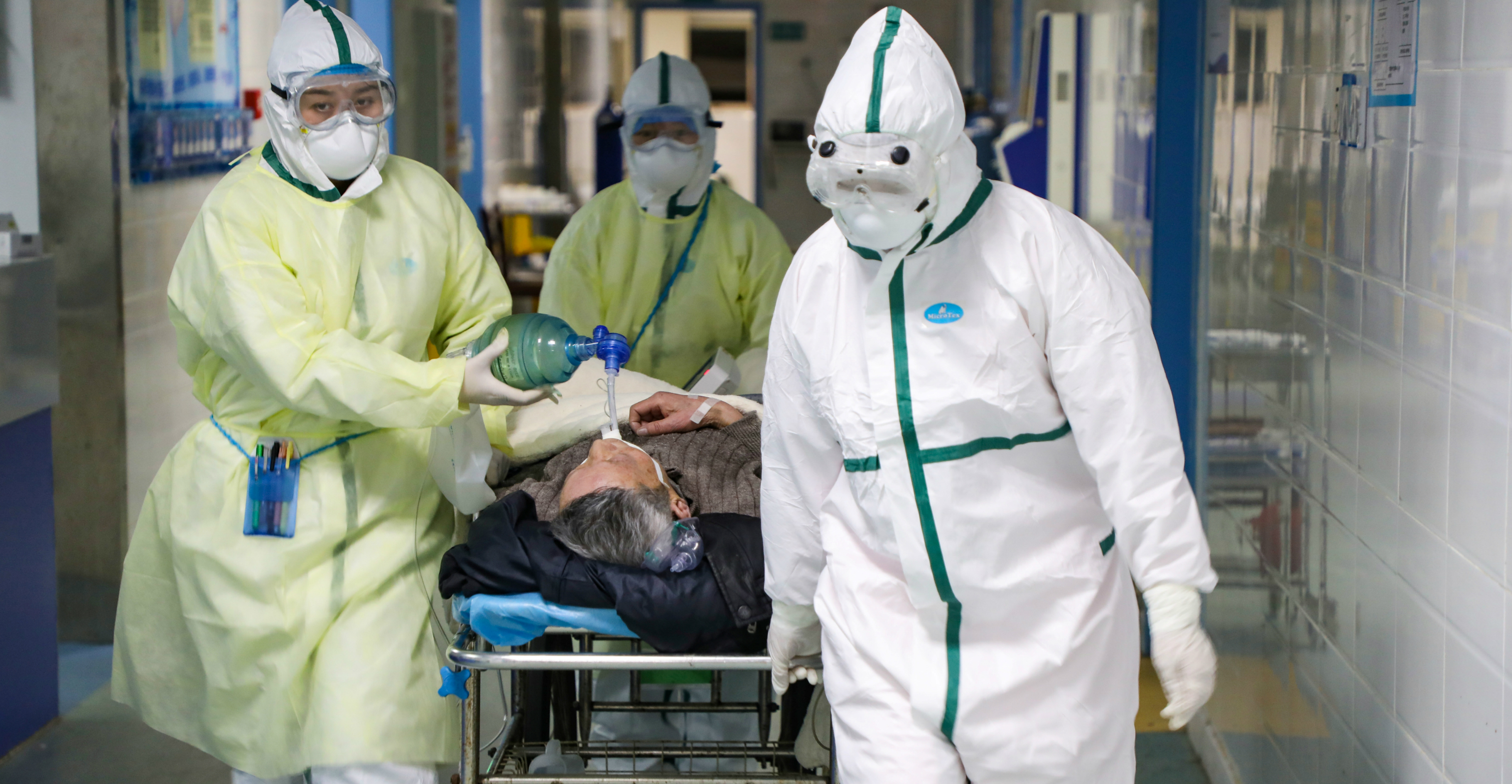 Medical workers in protective suits move a patient at an isolation ward of a hospital in Wuhan on Feb. 6. Photo: China Daily via Reuters Medical workers in protective suits move a patient at an isolation ward of a hospital in Wuhan on Feb. 6. Photo: China Daily via Reuters