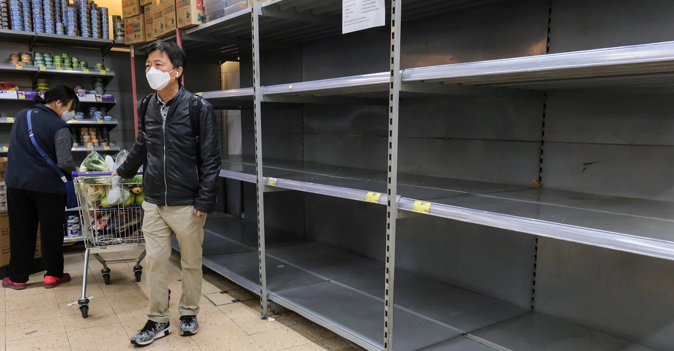Customers wearing masks walk past empty shelves at a supermarket amid panic-buying in the wake of the novel coronavirus outbreak. Photo: Reuters Customers wearing masks walk past empty shelves at a supermarket amid panic-buying in the wake of the novel coronavirus outbreak. Photo: Reuters