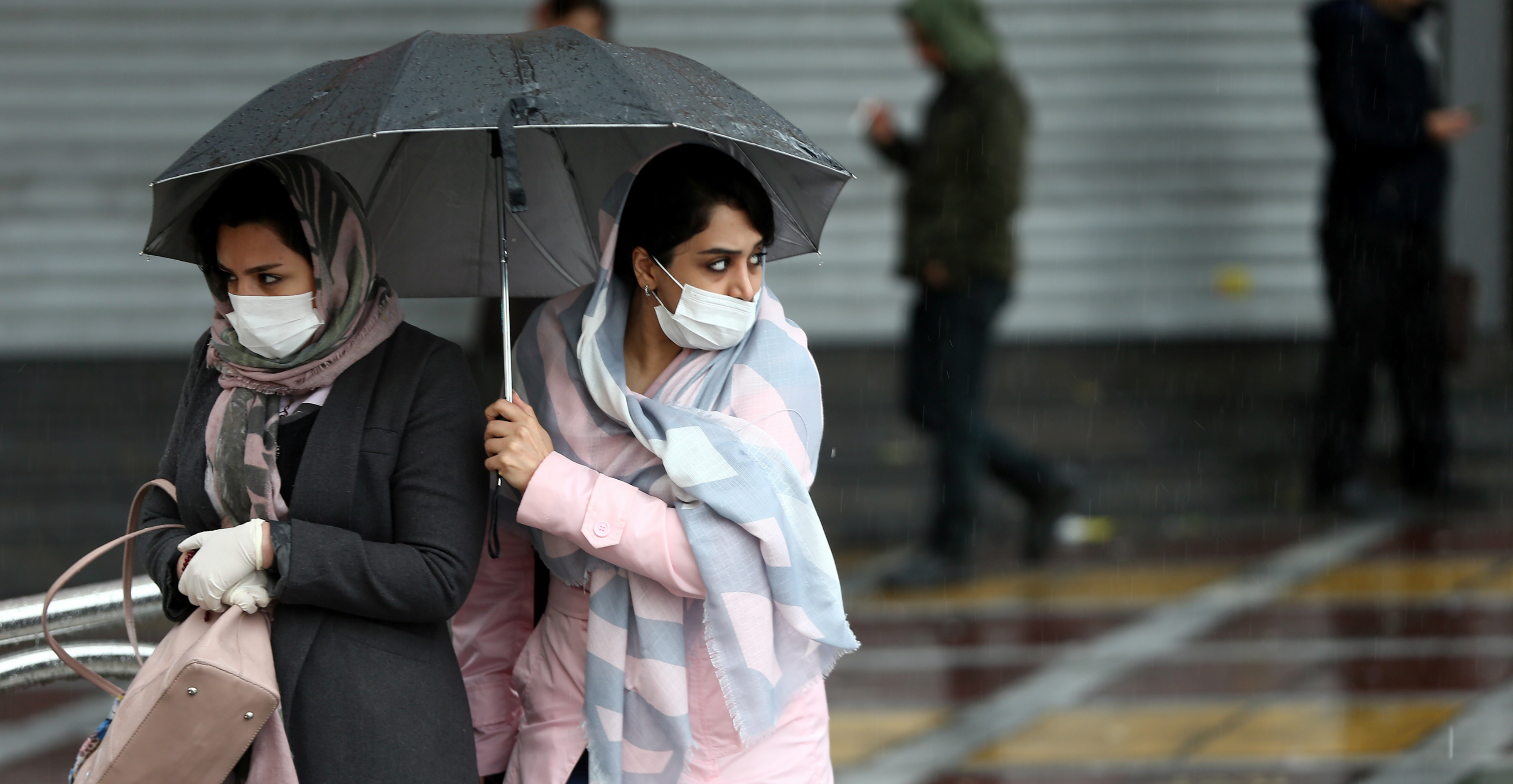 Iranian women wear protective masks as they walk on the street in Tehran on Tuesday. Photo: West Asia News Agency via Reuters Iranian women wear protective masks as they walk on the street in Tehran on Tuesday. Photo: West Asia News Agency via Reuters