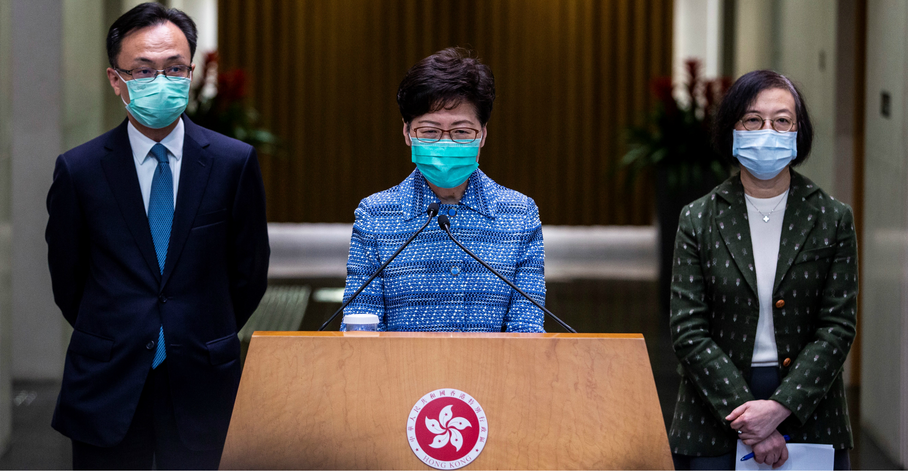 Chief Executive Carrie Lam is flanked by Secretary for Constitutional and Mainland Affairs Patrick Nip and Secretary for Food and Health Sophia Chan at a press conference on Tuesday. Photo: AFP Chief Executive Carrie Lam is flanked by Secretary for Constitutional and Mainland Affairs Patrick Nip and Secretary for Food and Health Sophia Chan at a press conference on Tuesday. Photo: AFP