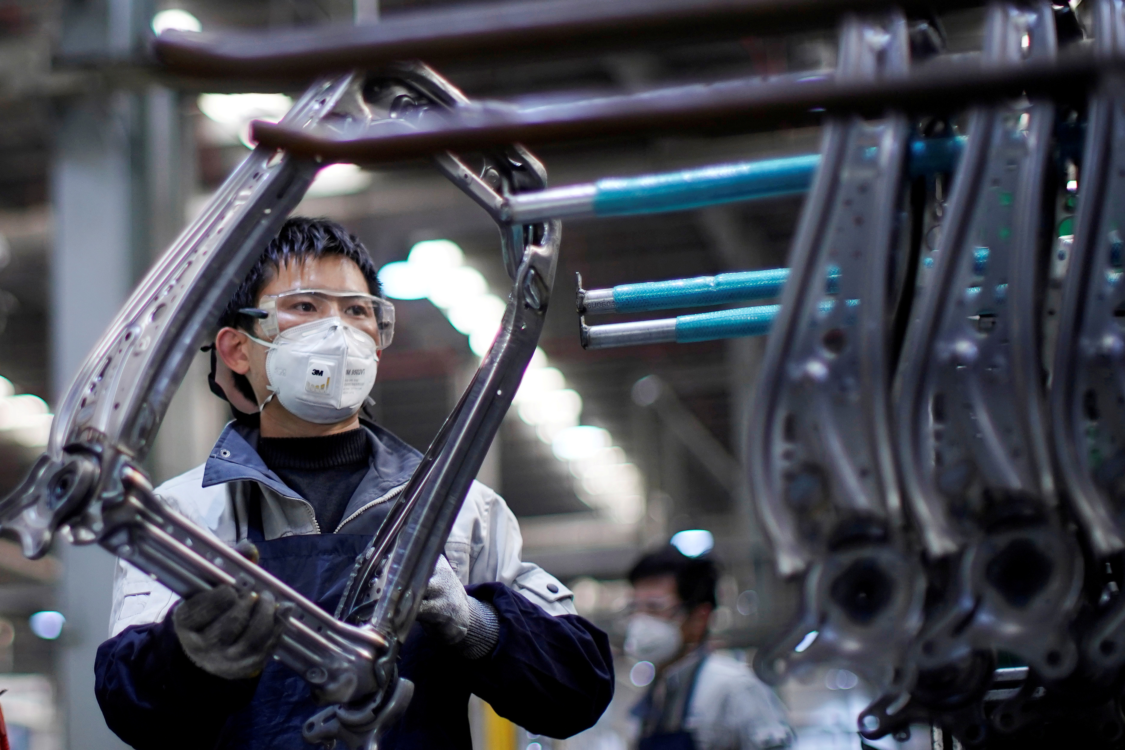 An employee wearing a face mask works on a car seat assembly line at a factory in Shanghai. China’s manufacturing and demand slump will affect activity elsewhere in the world, says PIMCO. Photo: Reuters An employee wearing a face mask works on a car seat assembly line at a factory in Shanghai. China’s manufacturing and demand slump will affect activity elsewhere in the world, says PIMCO. Photo: Reuters
