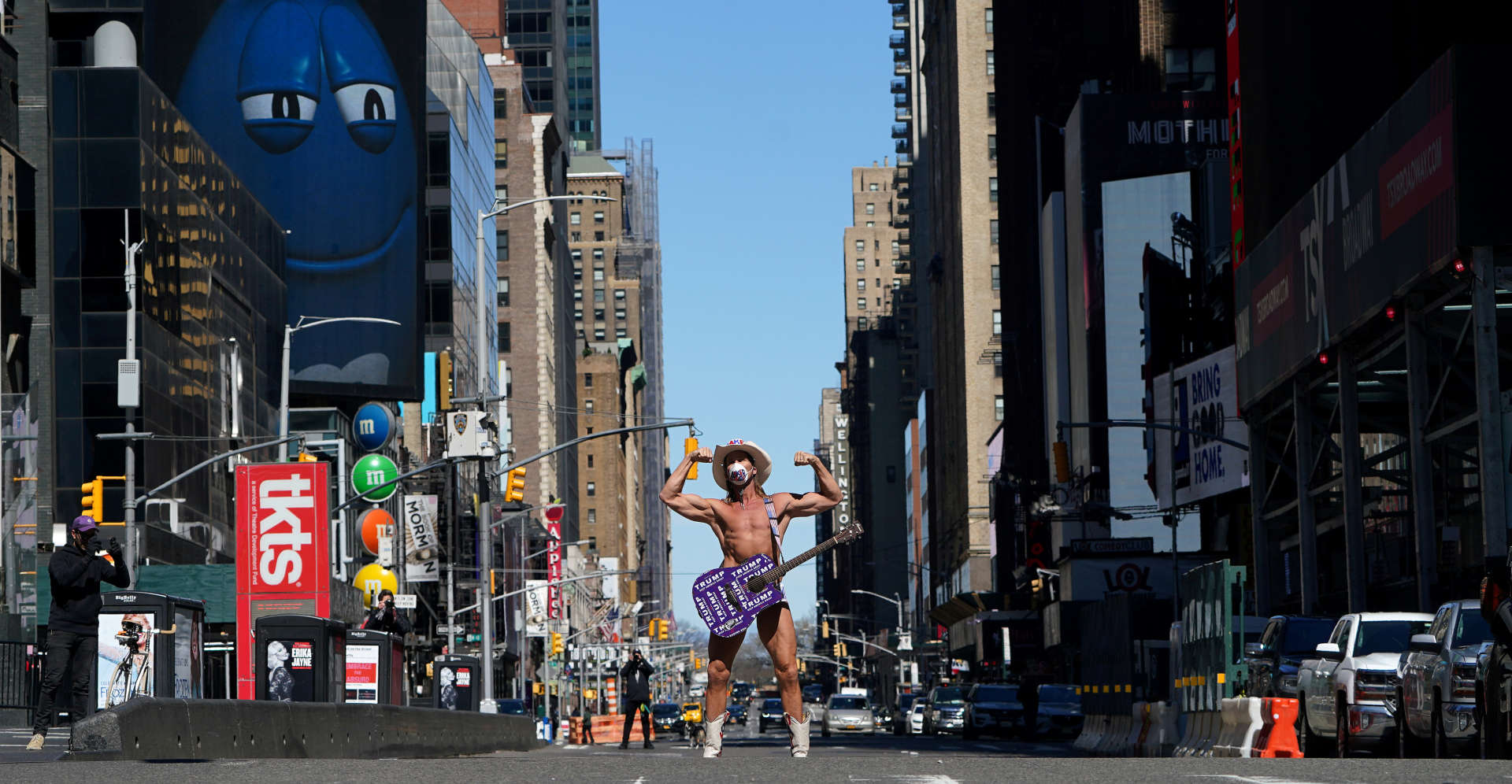 Robert Burck, known as the original "Naked Cowboy", poses for photos wearing a mask in a largely desolate Times Square in the Manhattan borough of New York City on Tuesday. Photo: Reuters Robert Burck, known as the original "Naked Cowboy", poses for photos wearing a mask in a largely desolate Times Square in the Manhattan borough of New York City on Tuesday. Photo: Reuters
