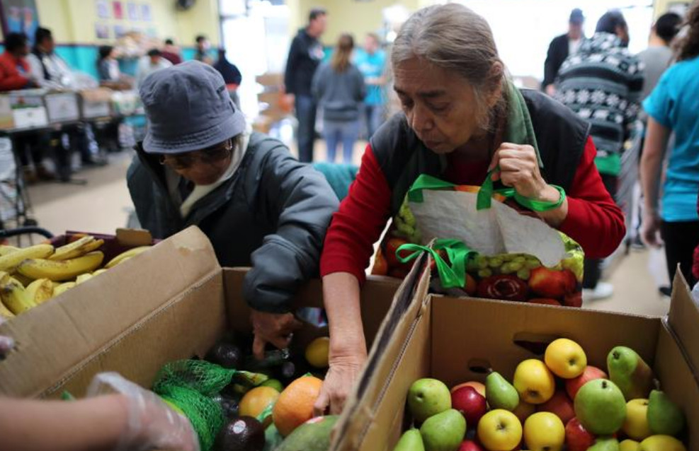 People receive food from a food bank. Photo: Reuters